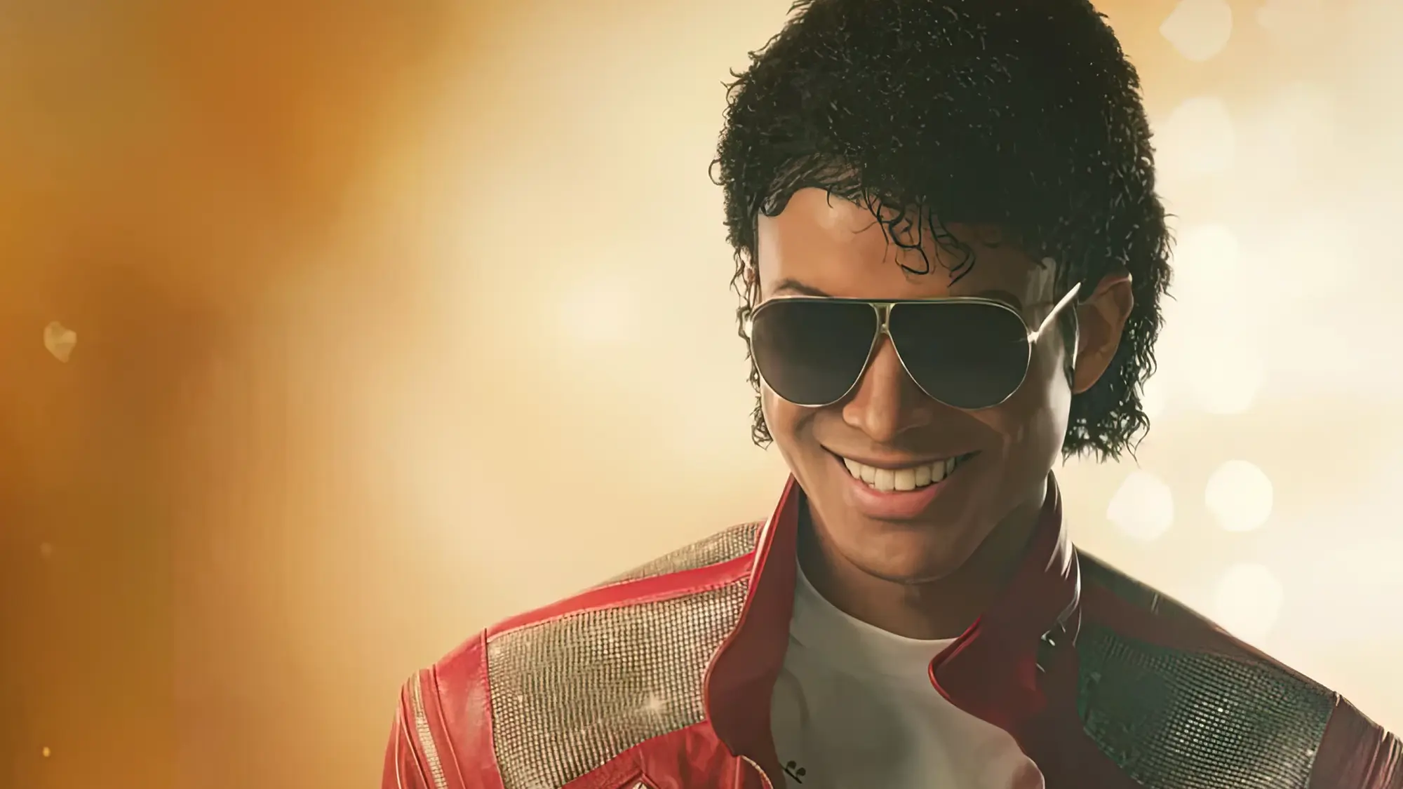 Jaafar Jackson portraying Michael Jackson in the 2026 biopic Michael wearing red jacket and aviator sunglasses
