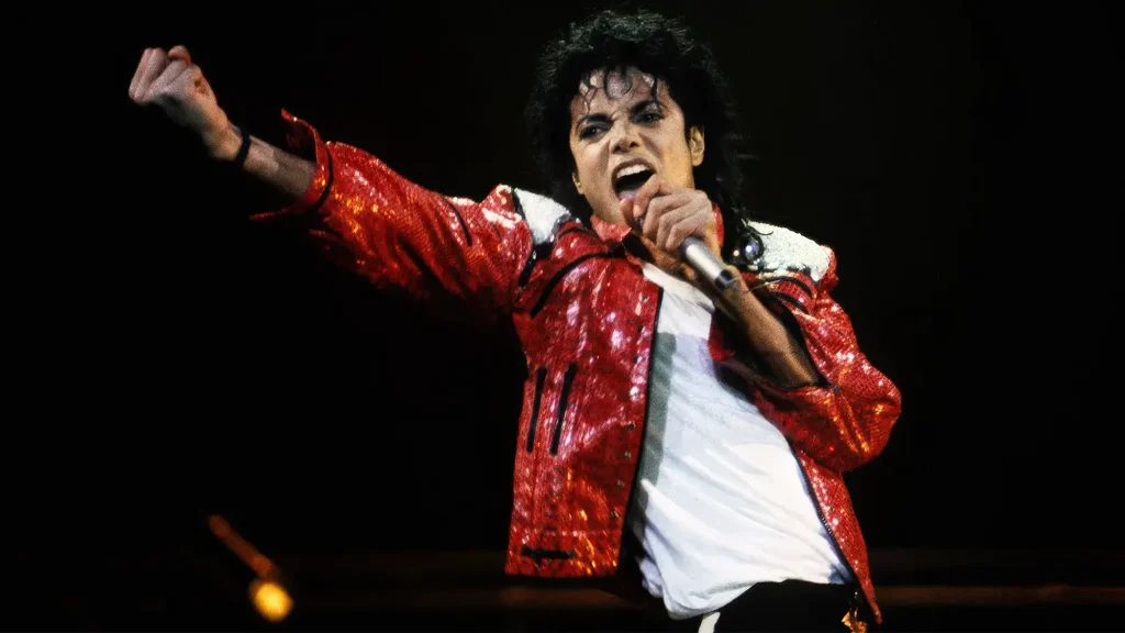 Michael Jackson performing live in red Thriller style jacket singing on stage
